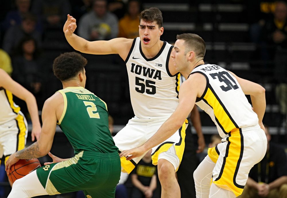 Iowa Hawkeyes center Luka Garza (55) and guard Connor McCaffery (30) pressure Cal Poly Mustangs forward Malek Harwell (2) during the first half of their game at Carver-Hawkeye Arena in Iowa City on Sunday, Nov 24, 2019. (Stephen Mally/hawkeyesports.com)