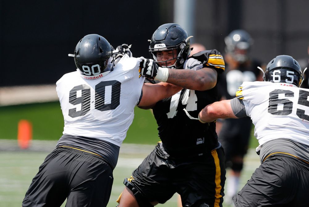 Iowa Hawkeyes offensive lineman Tristan Wirfs (74) and defensive end Sam Brincks (90) during fall camp practice No. 9 Friday, August 10, 2018 at the Kenyon Practice Facility. (Brian Ray/hawkeyesports.com)