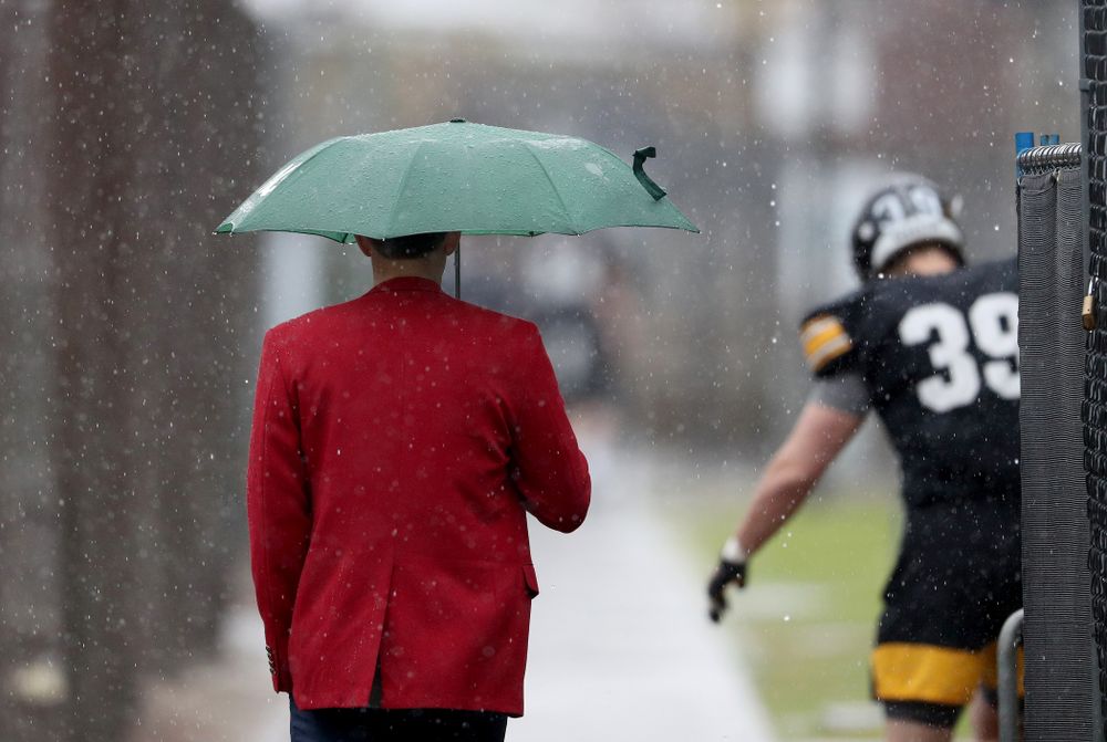 A Red Coat walks with the rain during practice Monday, December 23, 2019 at Mesa College in San Diego. (Brian Ray/hawkeyesports.com)