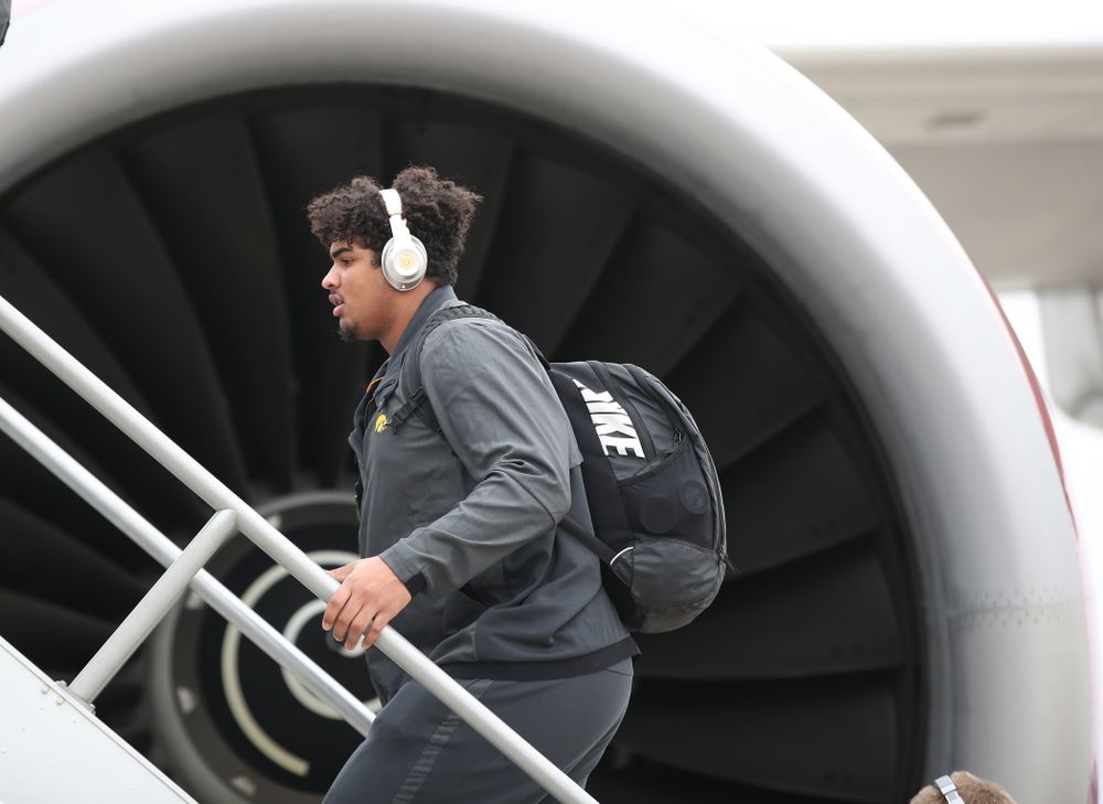 Iowa Hawkeyes offensive lineman Tristan Wirfs (74) boards the team plane Wednesday, December 26, 2018 as they travel to Tampa, Florida for the Outback Bowl. (Brian Ray/hawkeyesports.com)