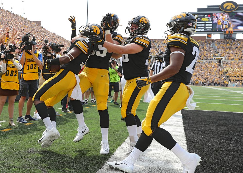 Iowa Hawkeyes wide receiver Tyrone Tracy Jr. (3) celebrates with tight end Nate Wieting (39), fullback Brady Ross (36), and running back Ivory Kelly-Martin (21) after his 7-yard touchdown reception during the second quarter of their Big Ten Conference football game at Kinnick Stadium in Iowa City on Saturday, Sep 7, 2019. (Stephen Mally/hawkeyesports.com)