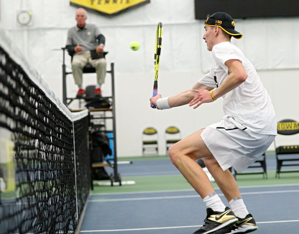 Iowa’s Nikita Snezhko returns a shot at the net during his doubles match at the Hawkeye Tennis and Recreation Complex in Iowa City on Sunday, February 16, 2020. (Stephen Mally/hawkeyesports.com)