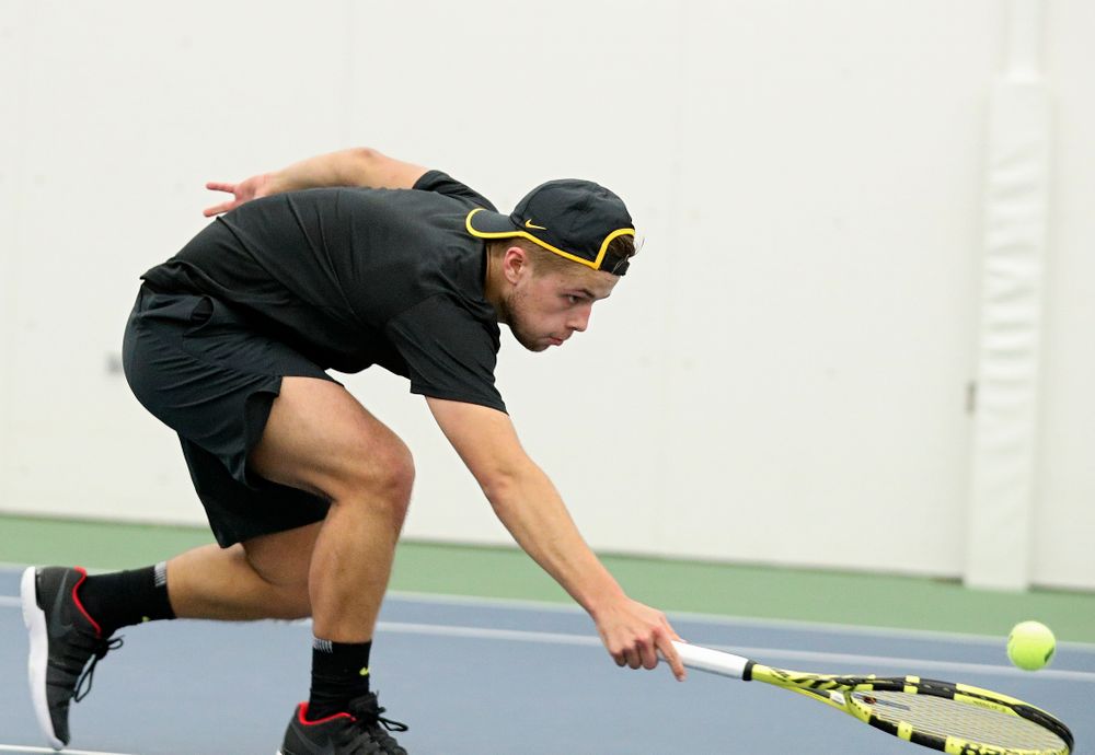 Iowa’s Will Davies reaches a ball during their match at the Hawkeye Tennis and Recreation Complex in Iowa City on Thursday, January 16, 2020. (Stephen Mally/hawkeyesports.com)