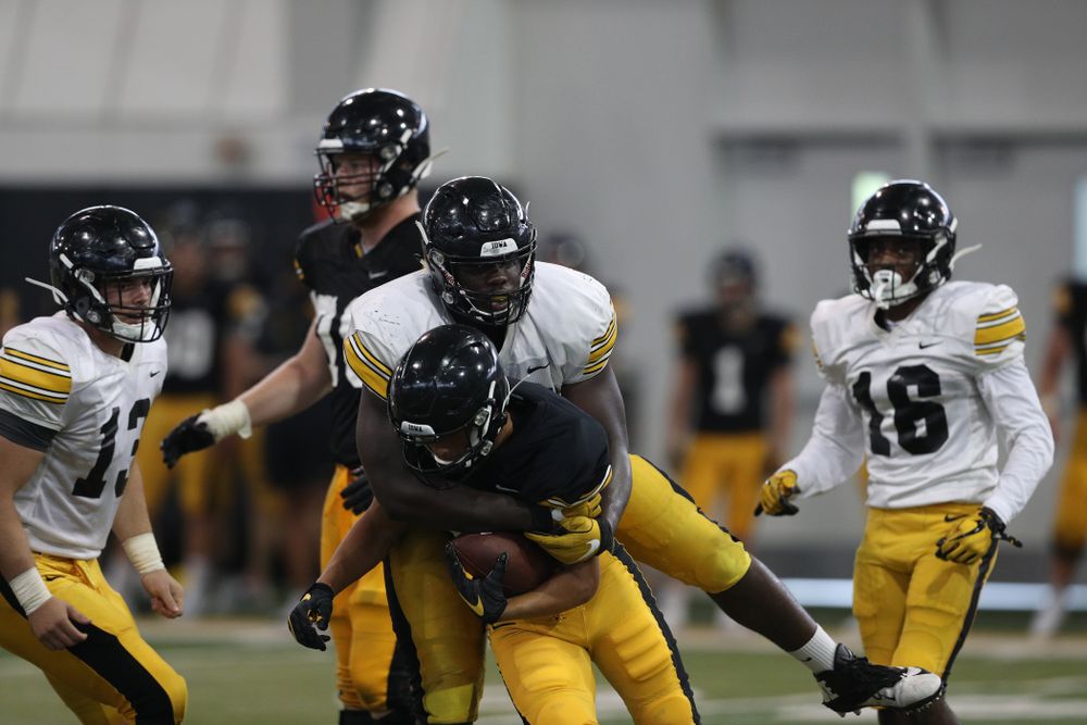 Iowa Hawkeyes defensive tackle Daviyon Nixon (54) and wide receiver Oliver Martin (5) During Fall Camp Practice No. 6 Thursday, August 8, 2019 at the Ronald D. and Margaret L. Kenyon Football Practice Facility. (Brian Ray/hawkeyesports.com)