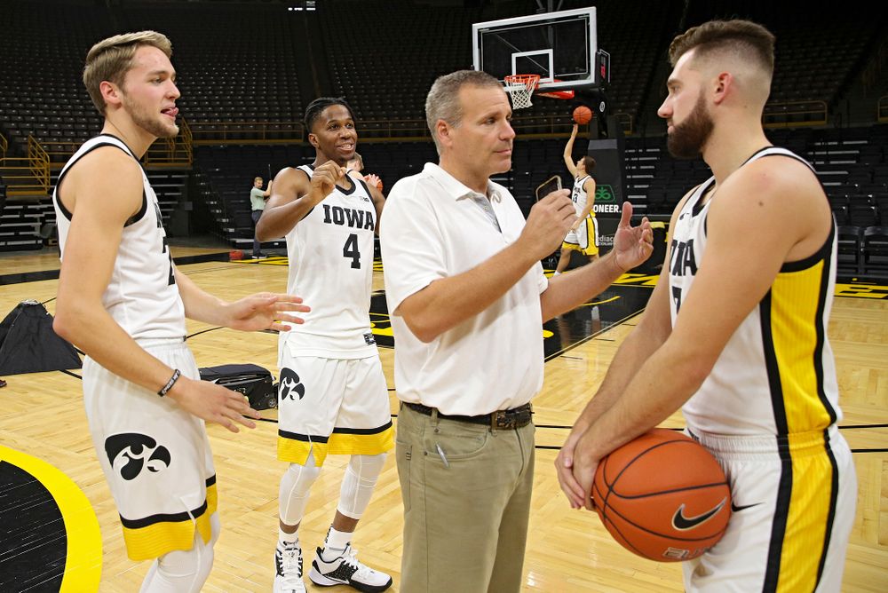 Iowa Hawkeyes forward Riley Till (20) and forward Bakari Evelyn (4) try to distract guard Jordan Bohannon (3) as he answers questions during Iowa Men’s Basketball Media Day at Carver-Hawkeye Arena in Iowa City on Wednesday, Oct 9, 2019. (Stephen Mally/hawkeyesports.com)
