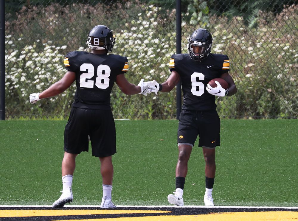 Iowa Hawkeyes running back Toren Young (28) and wide receiver Ihmir Smith-Marsette (6)