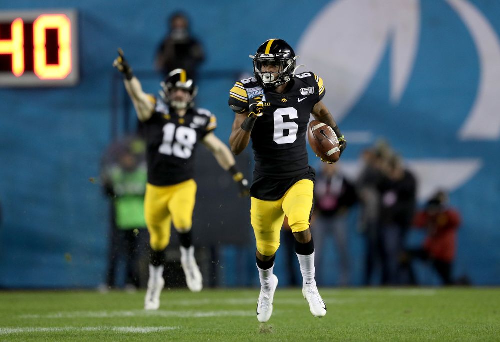 Iowa Hawkeyes wide receiver Ihmir Smith-Marsette (6) returns a kick for a touchdown against USC in the Holiday Bowl Friday, December 27, 2019 at San Diego Community Credit Union Stadium.  (Brian Ray/hawkeyesports.com)