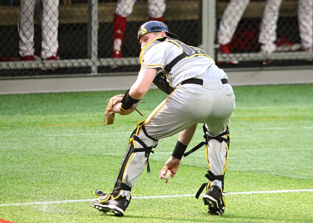 Iowa Hawkeyes catcher Brett McCleary (32) fields a bunt during the seventh inning of their CambriaCollegeClassic game at U.S. Bank Stadium in Minneapolis, Minn. on Friday, February 28, 2020. (Stephen Mally/hawkeyesports.com)