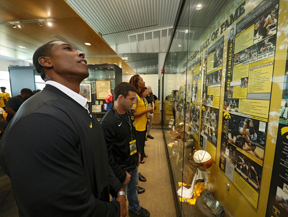2019 University of Iowa Athletics Hall of Fame inductee Jeremy Allen, Eric Juergens, and Tangela Smith look at their exhibit after it was unveiled at the University of Iowa Athletics Hall of Fame in Iowa City on Friday, Aug 30, 2019. (Stephen Mally/hawkeyesports.com)
