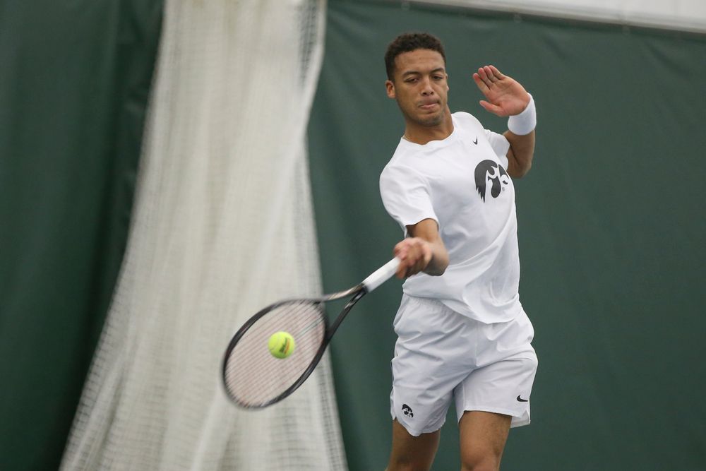 Iowa’s Oliver Okonkwo returns a hit during the Iowa men’s tennis meet vs Nebraska on Sunday, March 1, 2020 at the Hawkeye Tennis and Recreation Complex. (Lily Smith/hawkeyesports.com)