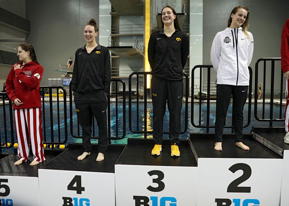 Iowa’s Allyssa Fluit (from left) and Hannah Burvill on the awards stand after swimming the women’s 200 yard freestyle final event during the 2020 Women’s Big Ten Swimming and Diving Championships at the Campus Recreation and Wellness Center in Iowa City on Friday, February 21, 2020. (Stephen Mally/hawkeyesports.com)