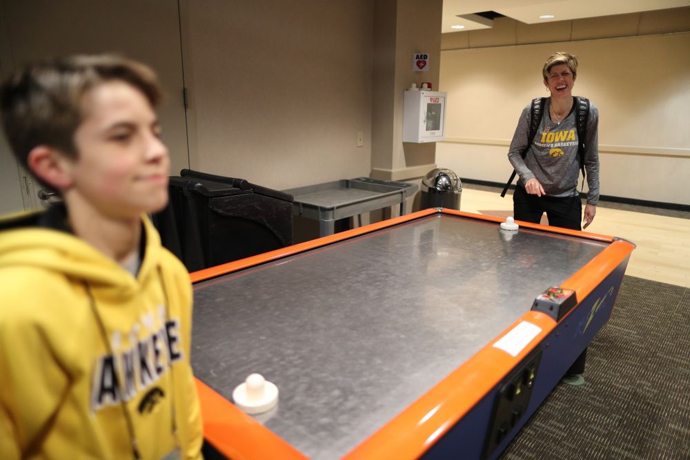 Associate head coach Jan Jensen plays air hockey with her son Jack following shoot around before their regional final against the Baylor Lady Bears in the 2019 NCAA Women's College Basketball Tournament Monday, April 1, 2019 at Greensboro Coliseum in Greensboro, NC.(Brian Ray/hawkeyesports.com)