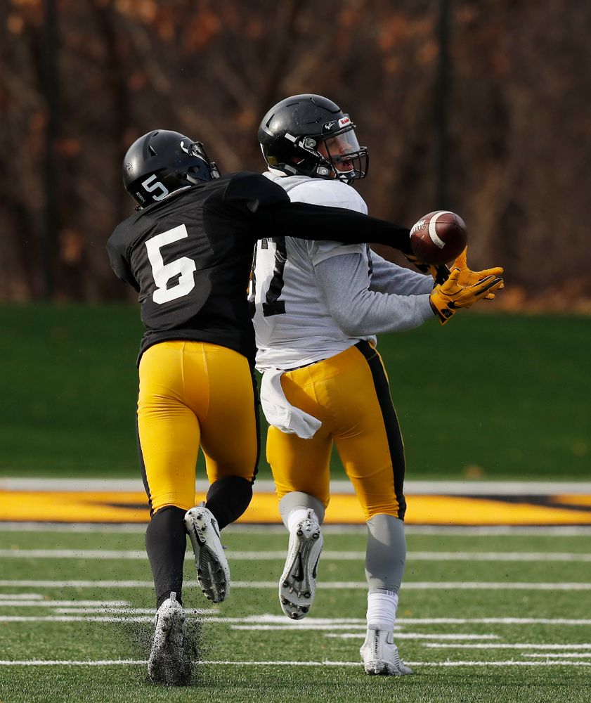 Iowa Hawkeyes defensive back Manny Rugamba (5) and tight end Noah Fant (87) 