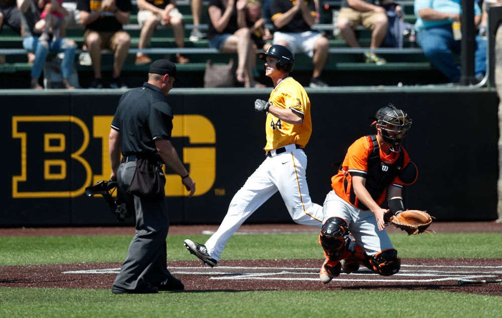 Iowa Hawkeyes outfielder Robert Neustrom (44) scores against the Oklahoma State Cowboys Sunday, May 6, 2018 at Duane Banks Field. (Brian Ray/hawkeyesports.com)