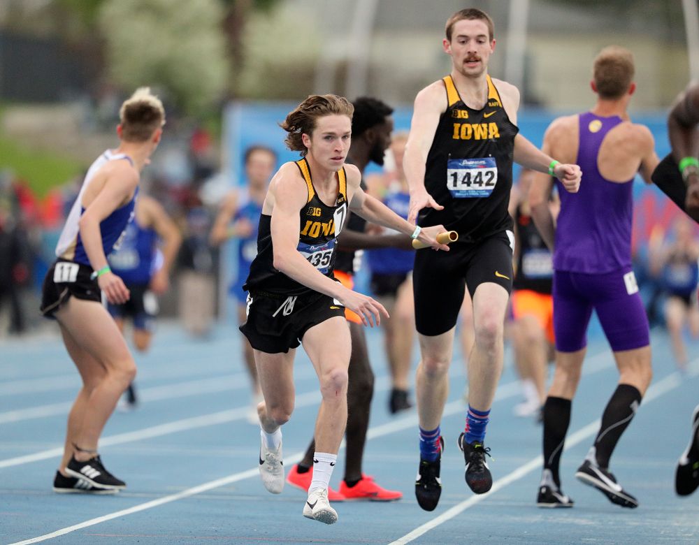 Iowa's Nathan Mylenek takes the baton from Nolan Teubel as they run the men's distance medley relay event during the third day of the Drake Relays at Drake Stadium in Des Moines on Saturday, Apr. 27, 2019. (Stephen Mally/hawkeyesports.com)
