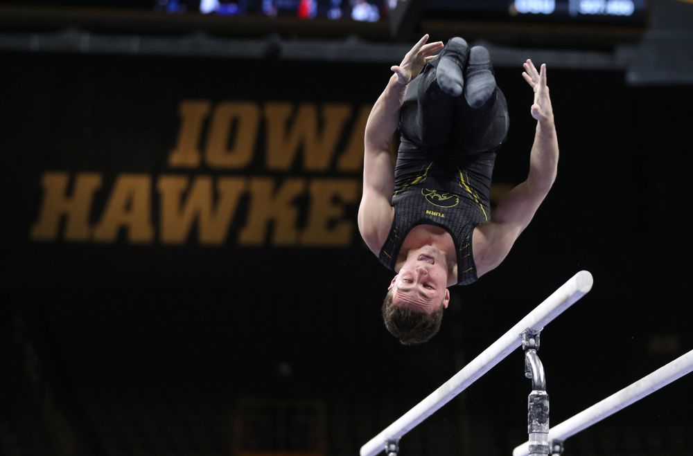 Iowa's Jake Brodarzon competes on the parallel bars against the Ohio State Buckeyes  Saturday, March 16, 2019 at Carver-Hawkeye Arena.  (Brian Ray/hawkeyesports.com)