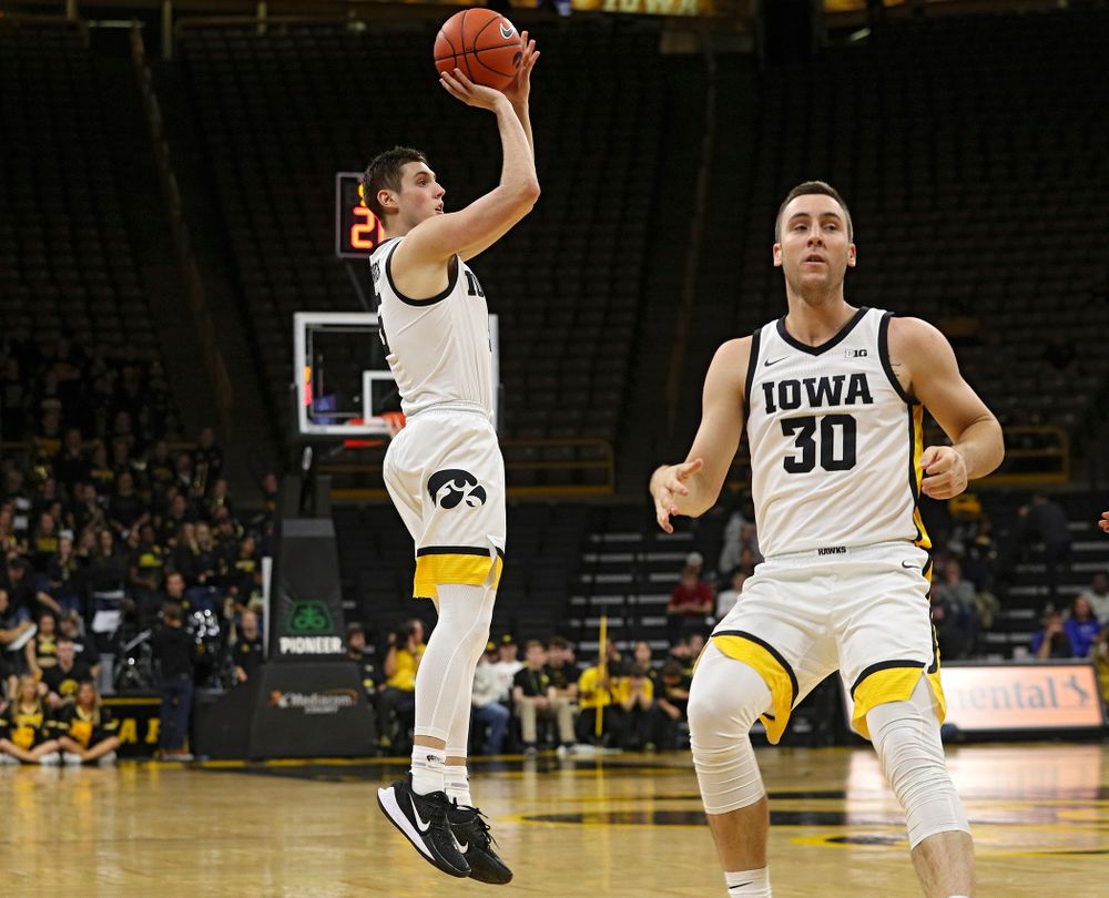Iowa Hawkeyes guard CJ Fredrick (5) makes a 3-pointer after taking a pass from guard Connor McCaffery (30) during the second half of their exhibition game against Lindsey Wilson College at Carver-Hawkeye Arena in Iowa City on Monday, Nov 4, 2019. (Stephen Mally/hawkeyesports.com)