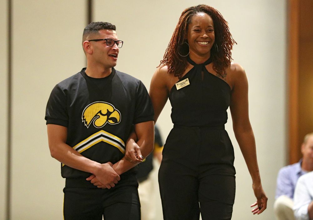 2019 University of Iowa Athletics Hall of Fame inductee Tengela Smith walks to her seat with a Spirit Squad member during the Hall of Fame Induction Ceremony at the Coralville Marriott Hotel and Conference Center in Coralville on Friday, Aug 30, 2019. (Stephen Mally/hawkeyesports.com)