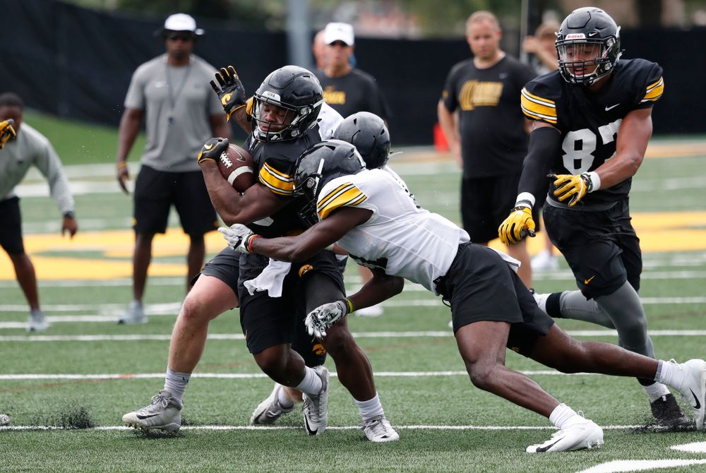 Iowa Hawkeyes running back Mekhi Sargent (10) and defensive back Michael Ojemudia (11) during practice No. 4 of Fall Camp Monday, August 6, 2018 at the Hansen Football Performance Center. (Brian Ray/hawkeyesports.com)