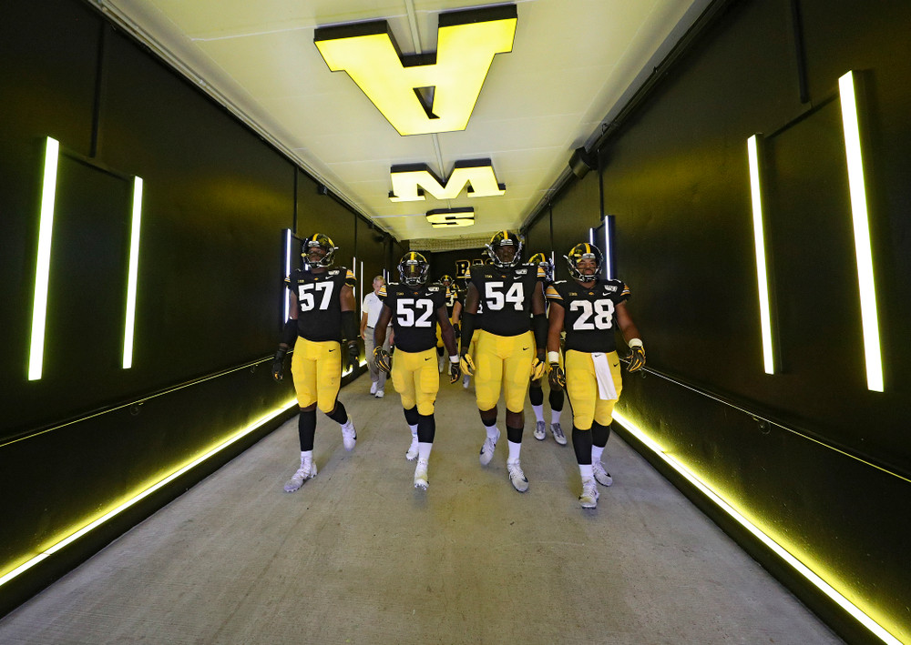 Iowa Hawkeyes defensive end Chauncey Golston (57), linebacker Amani Jones (52), defensive tackle Daviyon Nixon (54), and running back Toren Young (28) walk down the tunnel to take the field for the second half of their game at Kinnick Stadium in Iowa City on Saturday, Sep 28, 2019. (Stephen Mally/hawkeyesports.com)