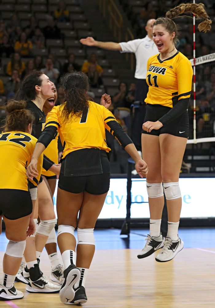 Iowa’s Blythe Rients (11) celebrates a block with Emily Bushman (12), Halle Johnston (4), Griere Hughes (10), and Brie Orr (7) during their match at Carver-Hawkeye Arena in Iowa City on Sunday, Oct 20, 2019. (Stephen Mally/hawkeyesports.com)