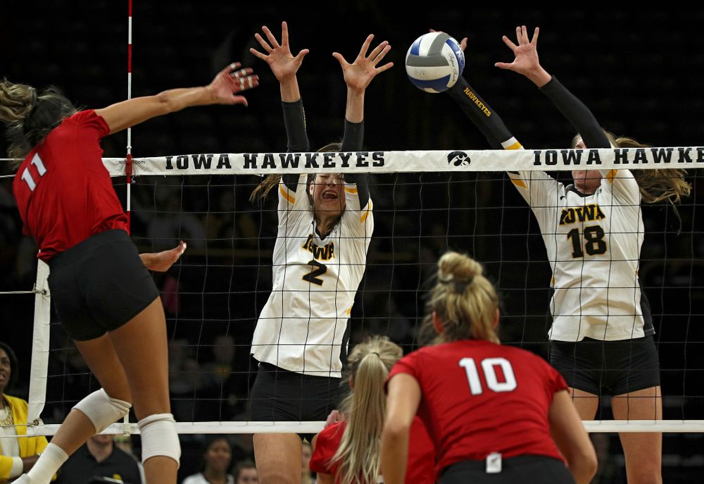 Iowa’s Courtney Buzzerio (2) and Hannah Clayton (18) try for a block during the first set of their match against Nebraska at Carver-Hawkeye Arena in Iowa City on Saturday, Nov 9, 2019. (Stephen Mally/hawkeyesports.com)