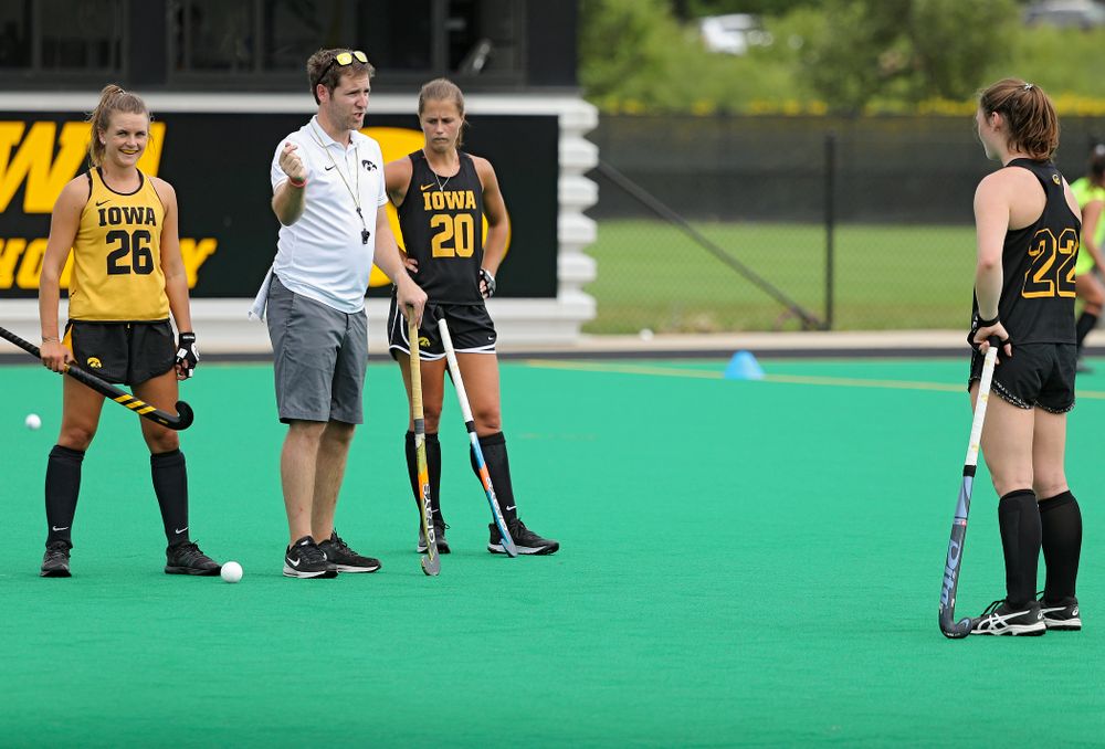 Iowa assistant coach Michael Boal talks with Maddy Murphy (26), Sophie Sunderland (20), and Ellie Flynn (22) as they work on a drill during practice at Grant Field in Iowa City on Thursday, Aug 15, 2019. (Stephen Mally/hawkeyesports.com)