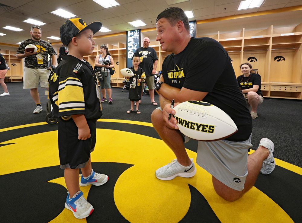 Kid Captain Jeg Weets (from left) talks with Iowa Hawkeyes offensive coordinator Brian Ferentz during Kids Day at Kinnick Stadium in Iowa City on Saturday, Aug 10, 2019. (Stephen Mally/hawkeyesports.com)