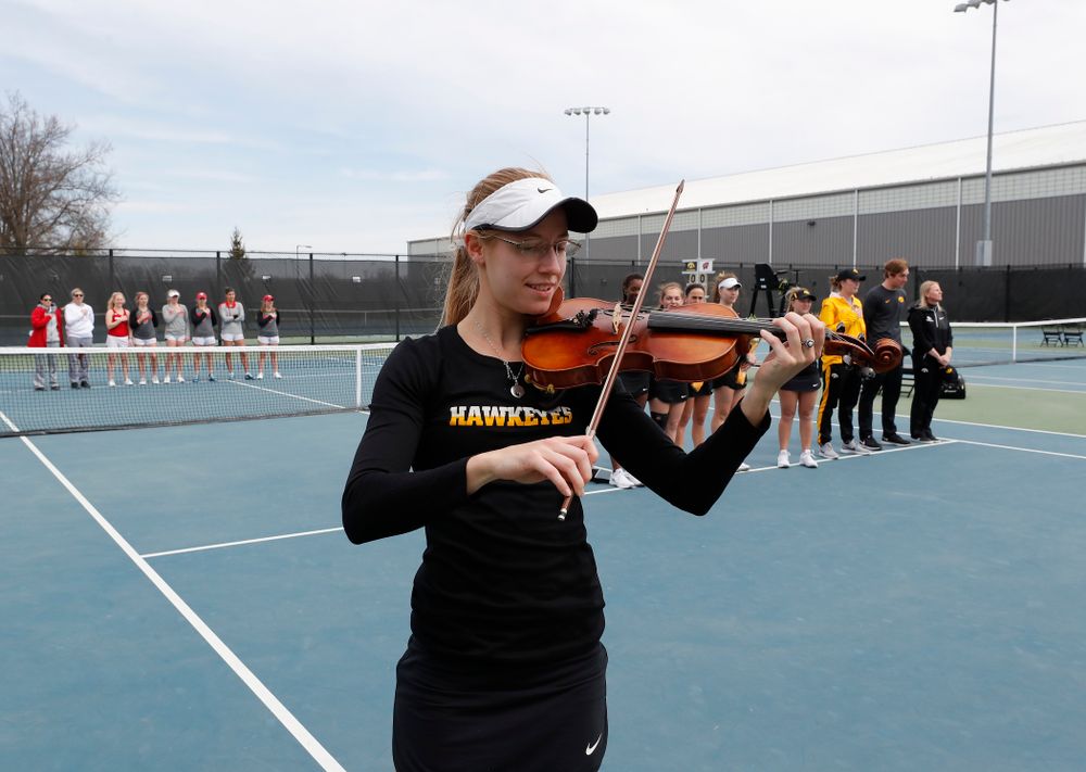 Iowa senior Montana Crawford plays the National Anthem before their match against the Wisconsin Badgers Sunday, April 22, 2018 at the Hawkeye Tennis and Recreation Center. (Brian Ray/hawkeyesports.com)