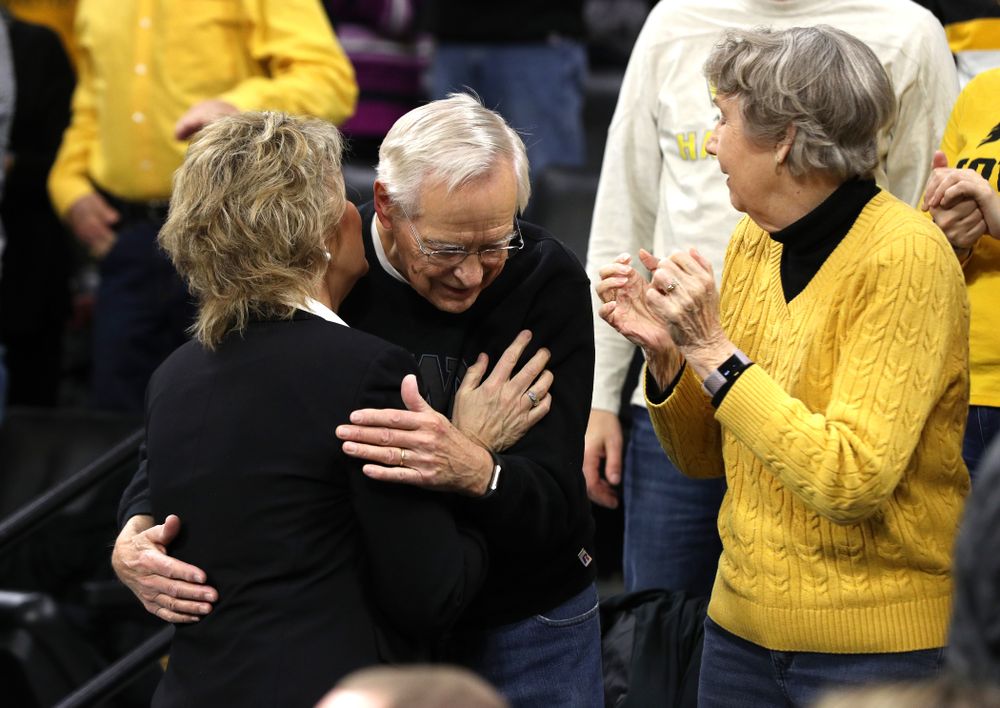 Iowa Hawkeyes head coach Lisa Bluder kisses her father before their game against the Northwestern Wildcats Sunday, March 3, 2019 at Carver-Hawkeye Arena. (Brian Ray/hawkeyesports.com)