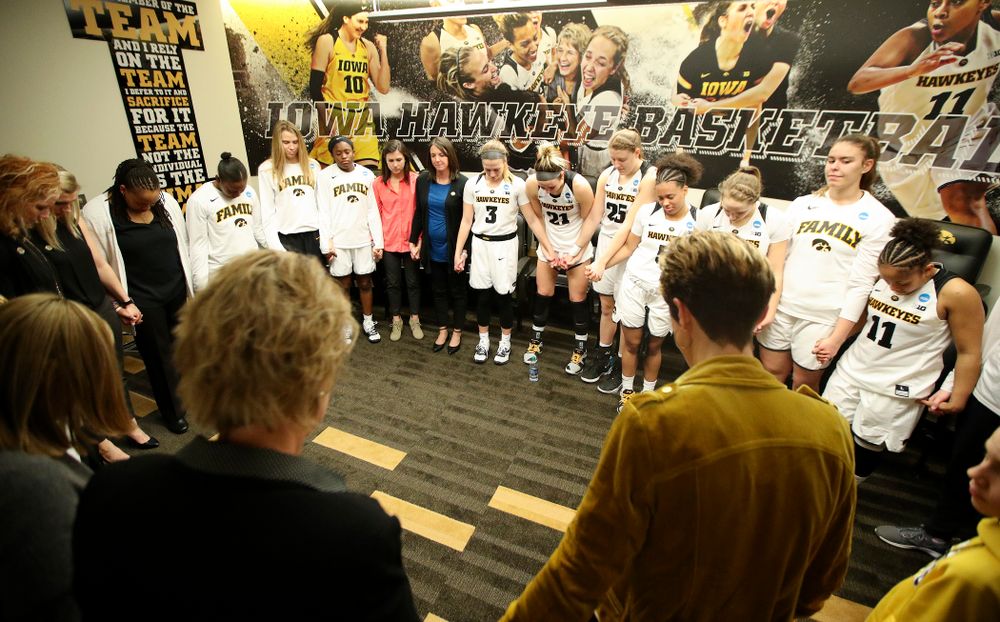 The Iowa Hawkeyes pray as a team in the locker room after winning their second round game in the 2019 NCAA Women's Basketball Tournament at Carver Hawkeye Arena in Iowa City on Sunday, Mar. 24, 2019. (Stephen Mally for hawkeyesports.com)