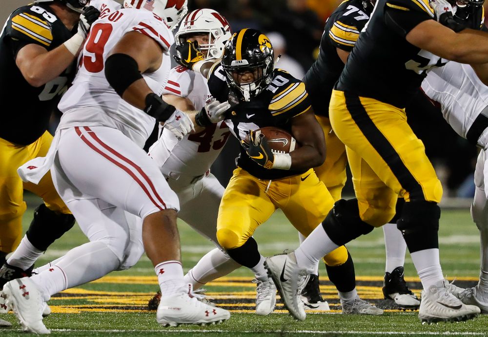 Iowa Hawkeyes running back Mekhi Sargent (10) stiff arms a defender during a game against Wisconsin at Kinnick Stadium on September 22, 2018. (Tork Mason/hawkeyesports.com)