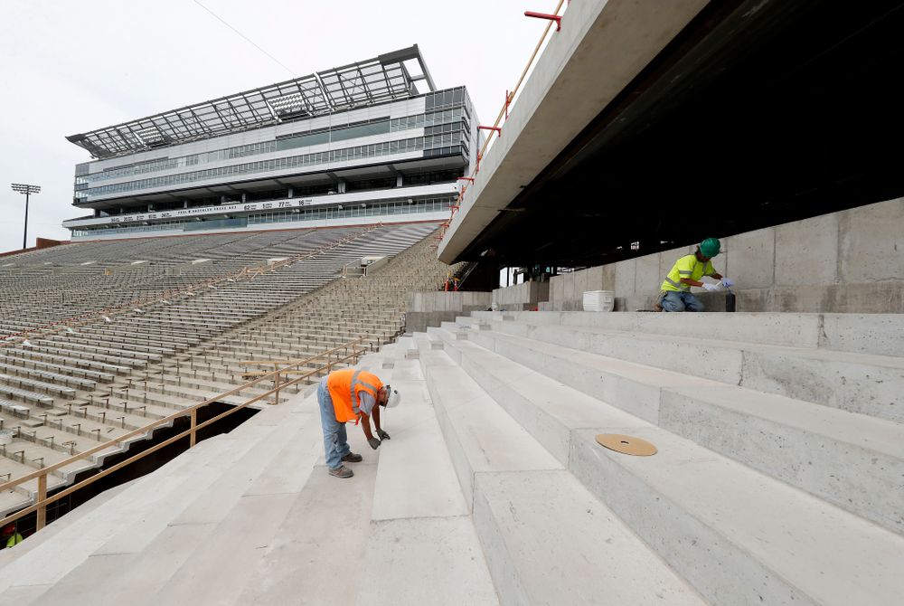 Workers measure in preparation for the installation of the bleachers in the lower bowl of the north end zone Wednesday, June 6, 2018 at Kinnick Stadium. (Brian Ray/hawkeyesports.com)