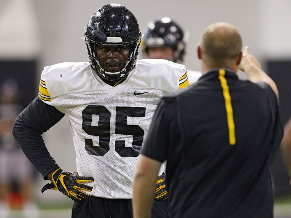 Iowa Hawkeyes defensive lineman Cedrick Lattimore (95) listens to Iowa Hawkeyes linebackers coach Seth Wallace during Fall Camp Practice No. 9 at the Hansen Football Performance Center in Iowa City on Monday, Aug 12, 2019. (Stephen Mally/hawkeyesports.com)