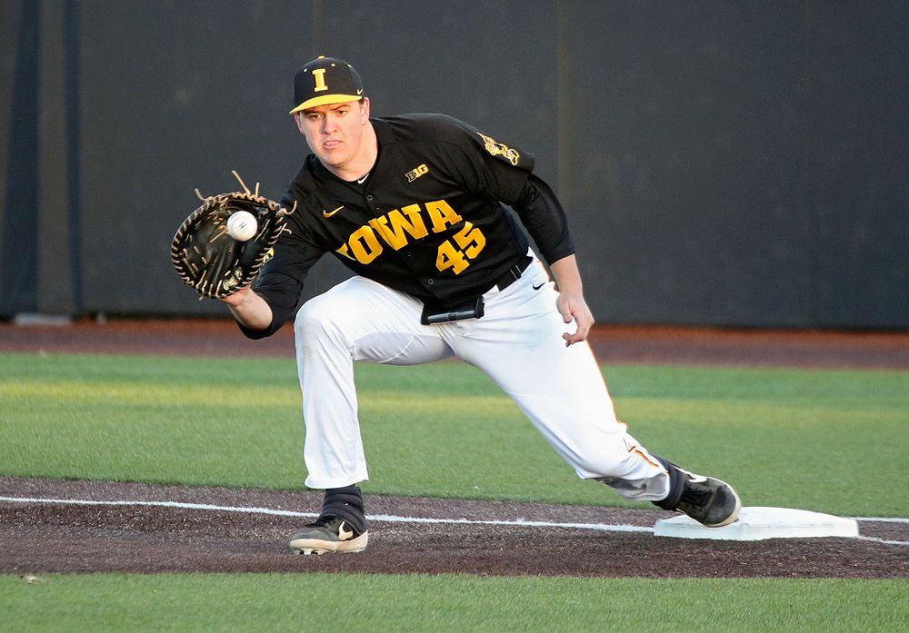 Iowa first baseman Peyton Williams (45) pulls in a throw during the fifth inning of their game at Duane Banks Field in Iowa City on Tuesday, March 3, 2020. (Stephen Mally/hawkeyesports.com)