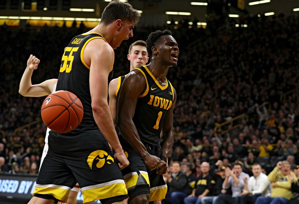 Iowa Hawkeyes guard Joe Toussaint (1) and center Luka Garza (55) celebrate after Toussaint scored a basket while being fouled during the first half of their game at Carver-Hawkeye Arena in Iowa City on Monday, January 27, 2020. (Stephen Mally/hawkeyesports.com)