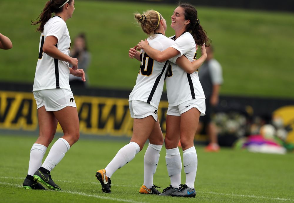 Iowa Hawkeyes midfielder/defender Natalie Winters (10) hugs forward Devin Burns (30) after scoring on a penalty kick during a 6-1 win over Northern Iowa Sunday, August 25, 2019 at the Iowa Soccer Complex. (Brian Ray/hawkeyesports.com)