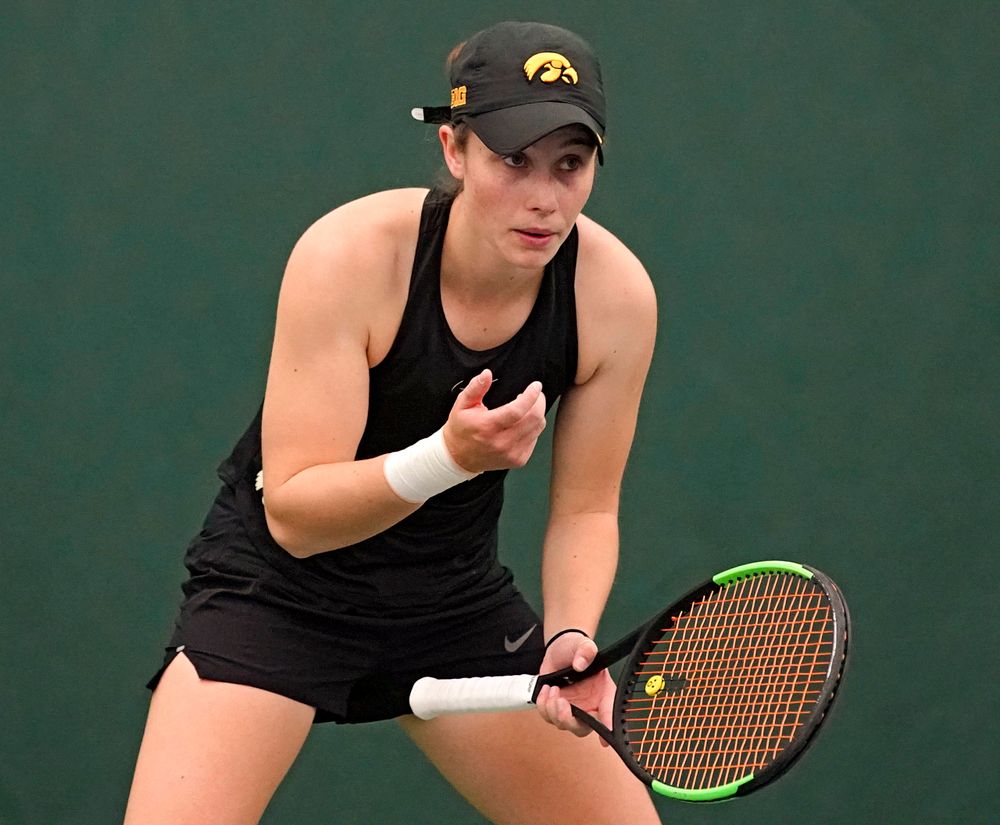 Iowa's Elise van Heuvelen Treadwell blows in her hand before a serve during a match against Indiana at the Hawkeye Tennis and Recreation Complex in Iowa City on Sunday, Mar. 31, 2019. (Stephen Mally/hawkeyesports.com)