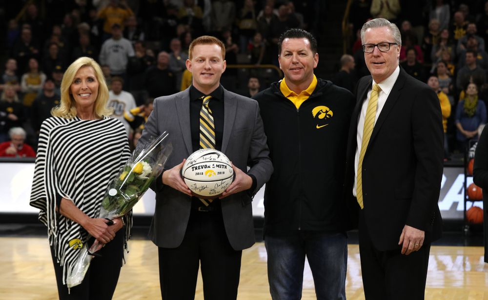 Senior Manager Trevor Smith stands with Iowa Hawkeyes head coach Fran McCaffery and his family during senior day activities before their game against the Rutgers Scarlet Knights  Saturday, March 2, 2019 at Carver-Hawkeye Arena. (Brian Ray/hawkeyesports.com)