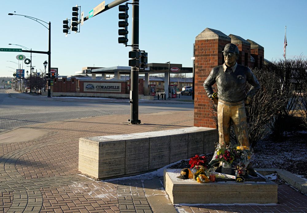A memorial at the base of the Hayden Fry statue in Coralville on Wednesday, December 18, 2019. Hayden Fry passed away on Dec. 17, at the age of 90. (Stephen Mally/hawkeyesports.com)