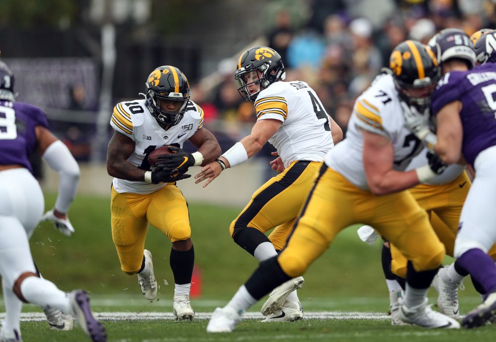 Iowa Hawkeyes running back Mekhi Sargent (10) and quarterback Nate Stanley (4) against the Northwestern Wildcats Saturday, October 26, 2019 at Ryan Field in Evanston, Ill. (Brian Ray/hawkeyesports.com)