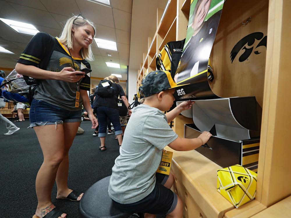 Kid Captain Jeg Weets looks at his gifts in his locker in the Iowa locker room during Kids Day at Kinnick Stadium in Iowa City on Saturday, Aug 10, 2019. (Stephen Mally/hawkeyesports.com)