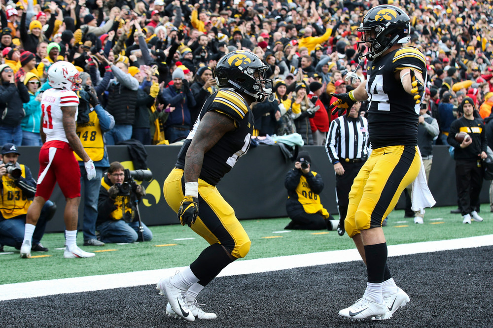 Iowa Hawkeyes running back Mekhi Sargent (10) and Iowa Hawkeyes wide receiver Nick Easley (84) celebrate after Sargent's touchdown during a game against Nebraska at Kinnick Stadium on November 23, 2018. (Tork Mason/hawkeyesports.com)