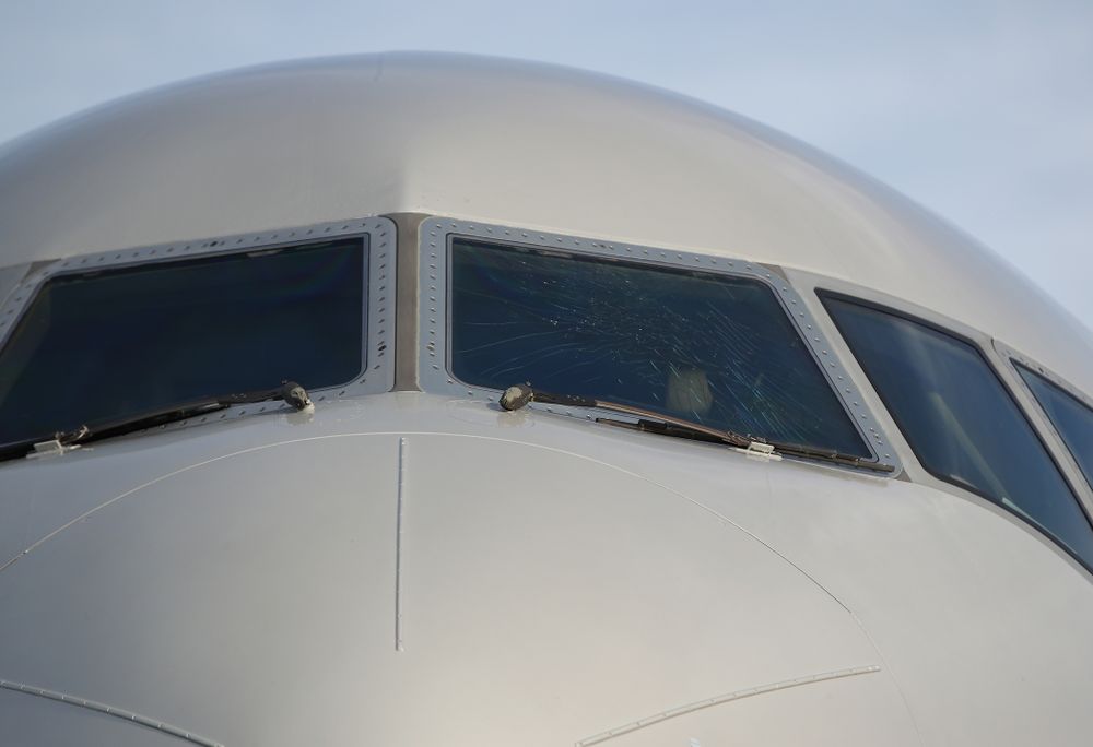 The outer layer of the front windscreen of the team plane is cracked Wednesday, December 26, 2018 as the Iowa Hawkeyes arrive in Tampa, Florida for the Outback Bowl. The flight crew scheduled to take the plane said the damage happened in flight and was due to fatigue from pressure changes in the air. (Brian Ray/hawkeyesports.com)