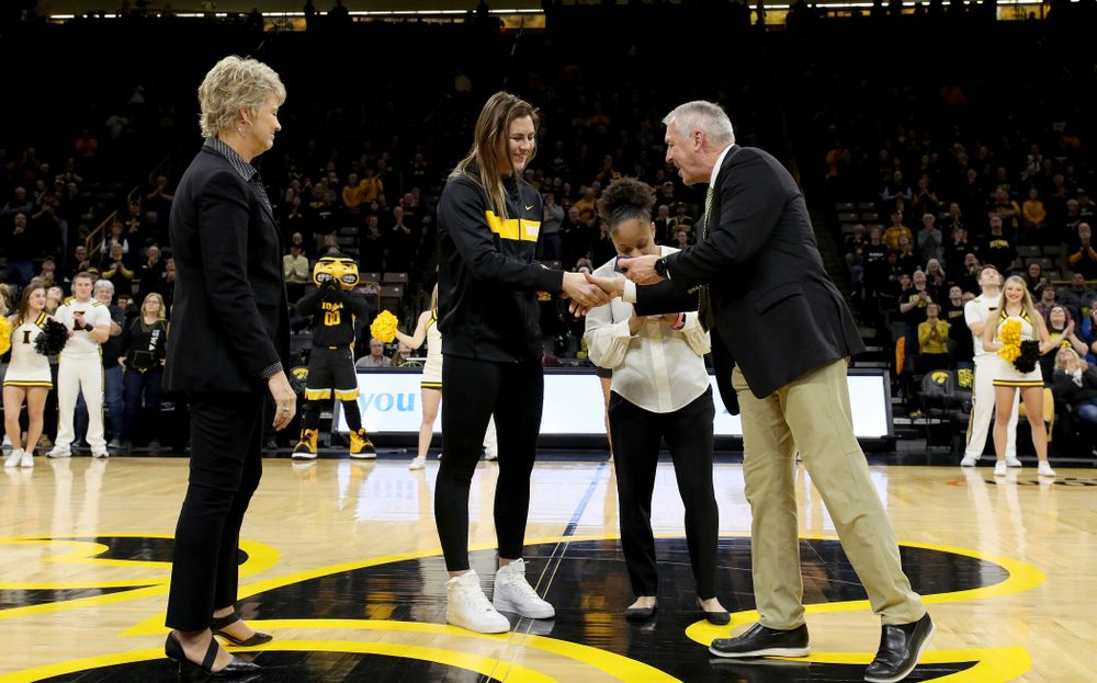 Former Hawkeye Hannah Stewart receives her Big Ten Tournament championship ring from Henry B. and Patricia B. Tippie Director of Athletics Chair Gary Barta before their game Clemson Wednesday, December 4, 2019 at Carver-Hawkeye Arena. (Brian Ray/hawkeyesports.com)