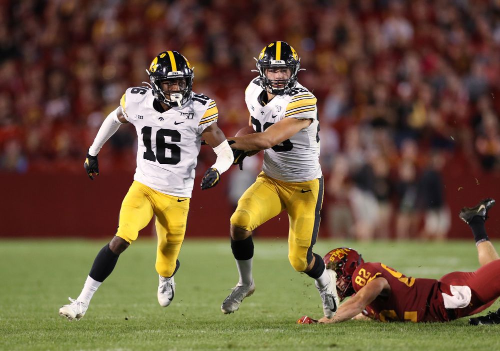Iowa Hawkeyes wide receiver Nico Ragaini (89) runs behind defensive back Terry Roberts (16)  as he returns a punt against the Iowa State Cyclones Saturday, September 14, 2019 in Ames, Iowa. (Brian Ray/hawkeyesports.com)