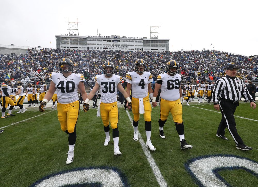 Iowa Hawkeyes captains defensive end Parker Hesse (40), defensive back Jake Gervase (30), quarterback Nate Stanley (4), and offensive lineman Keegan Render (69) against the Penn State Nittany Lions Saturday, October 27, 2018 at Beaver Stadium in University Park, Pa. (Brian Ray/hawkeyesports.com)