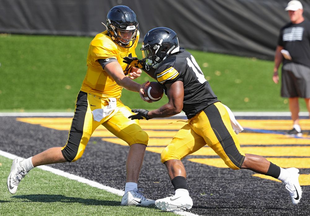 Iowa Hawkeyes quarterback Nate Stanley (4) hands the ball off to running back Mekhi Sargent (10) during Fall Camp Practice #5 at the Hansen Football Performance Center in Iowa City on Tuesday, Aug 6, 2019. (Stephen Mally/hawkeyesports.com)