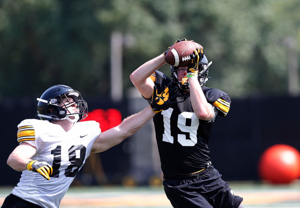 Iowa Hawkeyes wide receiver Max Cooper (19) and defensive back John Milani (18) during practice No. 7 of fall camp Friday, August 10, 2018 at the Kenyon Football Practice Facility. (Brian Ray/hawkeyesports.com)