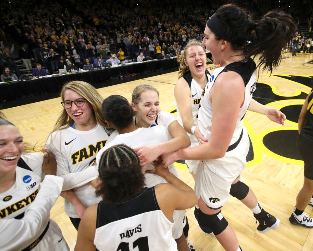 Iowa Hawkeyes center Megan Gustafson (10) jumps in the air as she celebrates with her teammates after winning their second round game in the 2019 NCAA Women's Basketball Tournament at Carver Hawkeye Arena in Iowa City on Sunday, Mar. 24, 2019. (Stephen Mally for hawkeyesports.com)